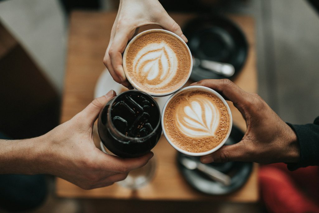 A cup of coffee on a table by a window
