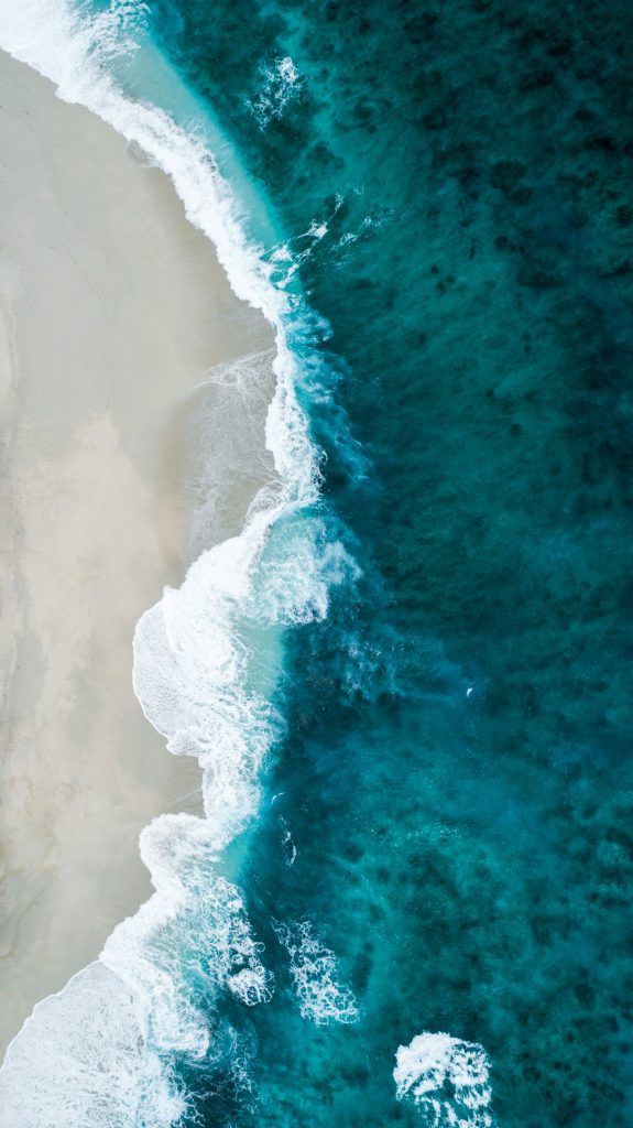 Small waves rolling onto an empty shore
